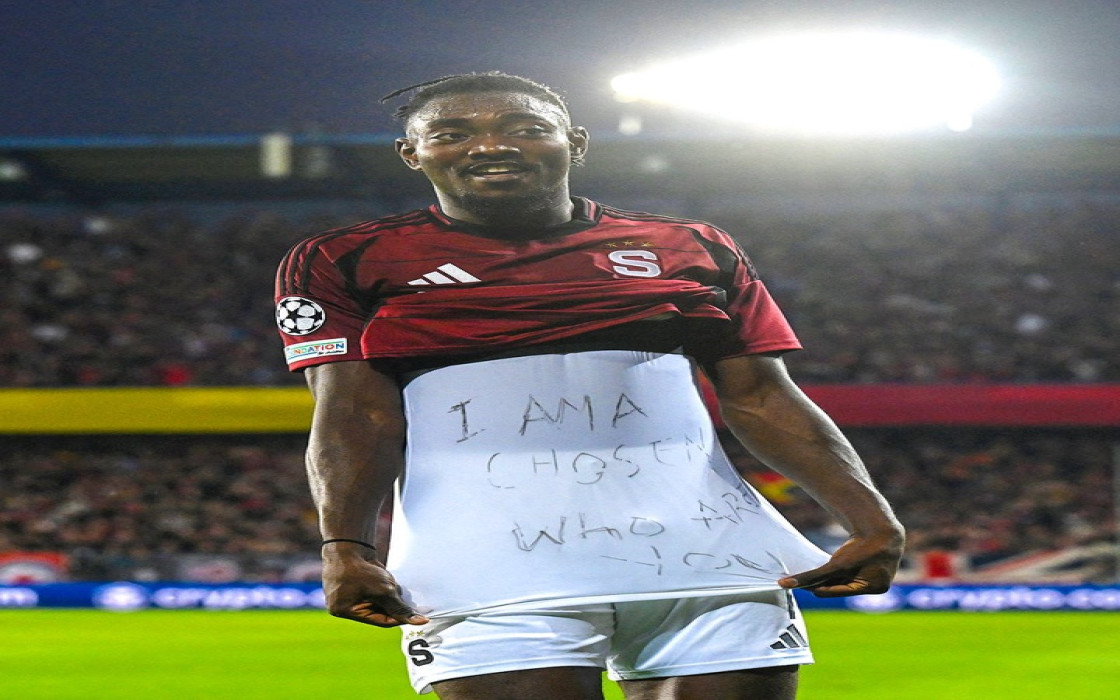 Victor Olatunji shows off “I am a chosen, who are you?” written on his undershirt.